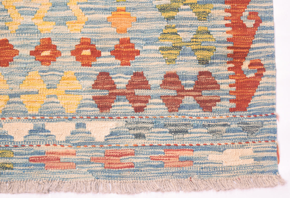 Handwoven kilim rug bottom border with fringe and repeating geometric icons