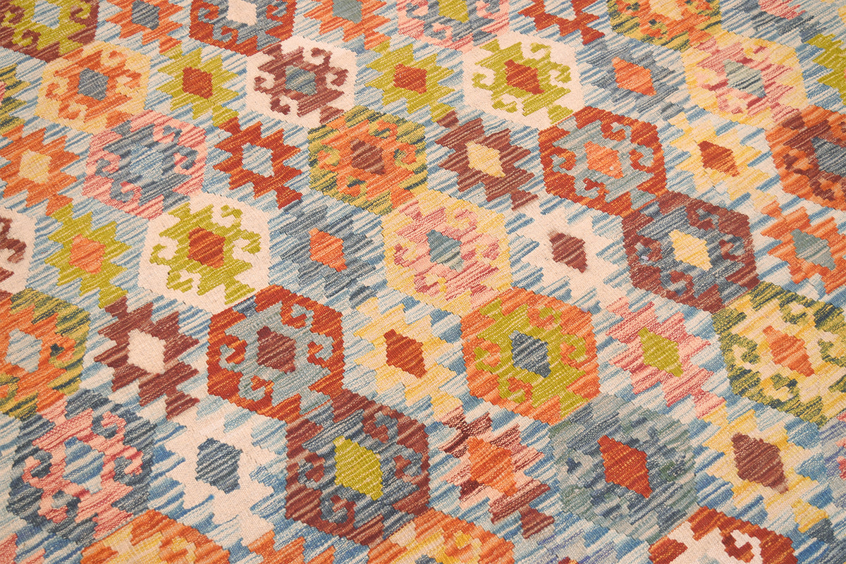 Handwoven kilim rug close-up of colorful geometric rows and dotted motifs