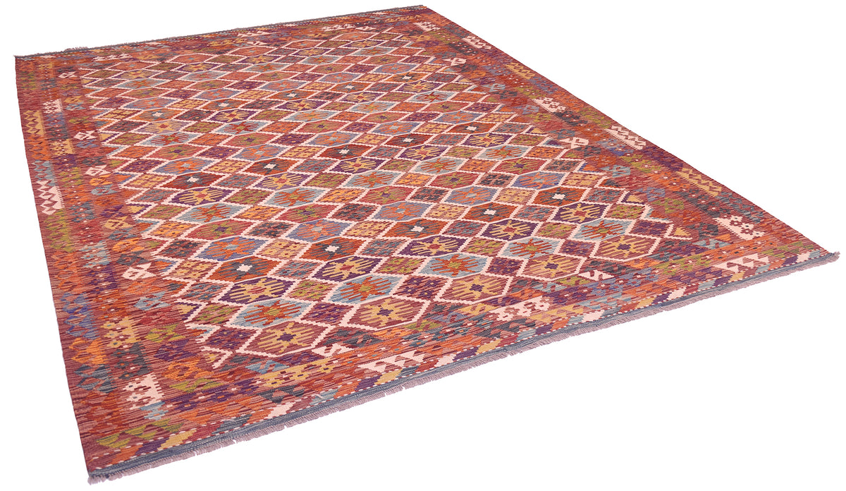 Handwoven kilim rug with multicolor geometric pattern in a diagonal corner view.