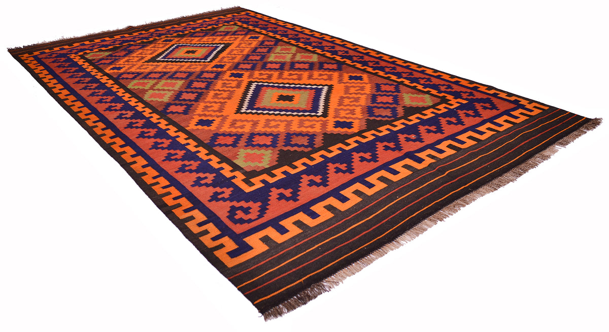 Colorful vintage Kilim rug laid angled, featuring bold orange and navy geometric pattern.