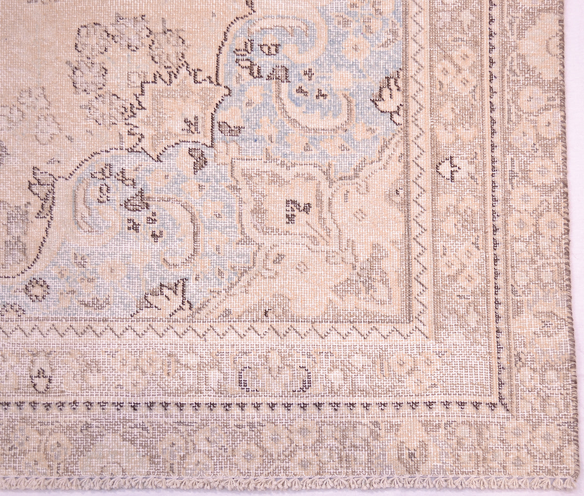 Corner and border of vintage handmade carpet with softened colours and shaved decolorised pile for enhanced vintage effect. Soft powder blues in corner sprandrels. Highly floral border and geometric minor borders/gaurd stripes.