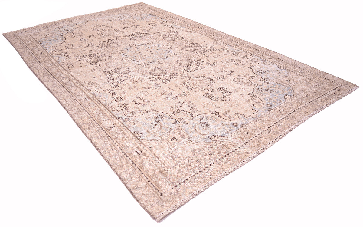 Angled view of handknotted vintage oriental floral medallion carpet with soft beige cream ground with detailing of mid brown and dark brown defining outlining.