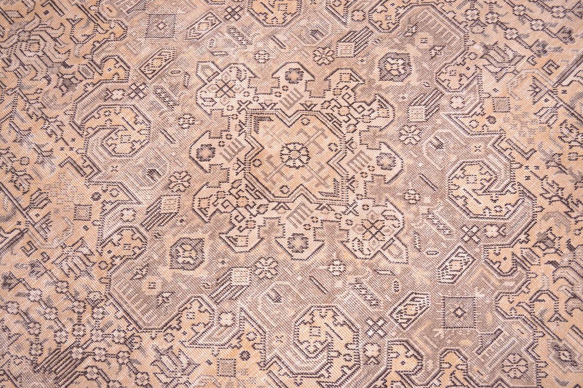 Detailed close up view of main medallion fo floral geometric carpet with beige, gold, brown and hints of sage green. Handknotted vintage carpet with zero pile but sturdy cotton foundation warps.