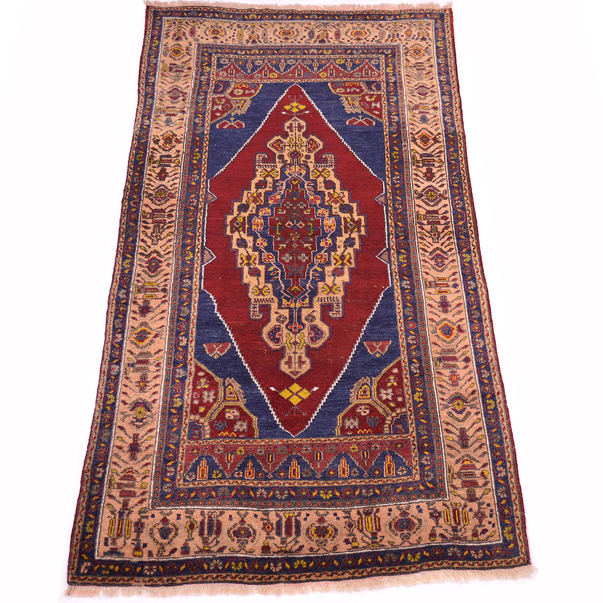 A traditional old Turkish-style Yahyali wool rug with a central red medallion, blue corners, and apricot borders with intricate geometric patterns, shown flat against a white background.