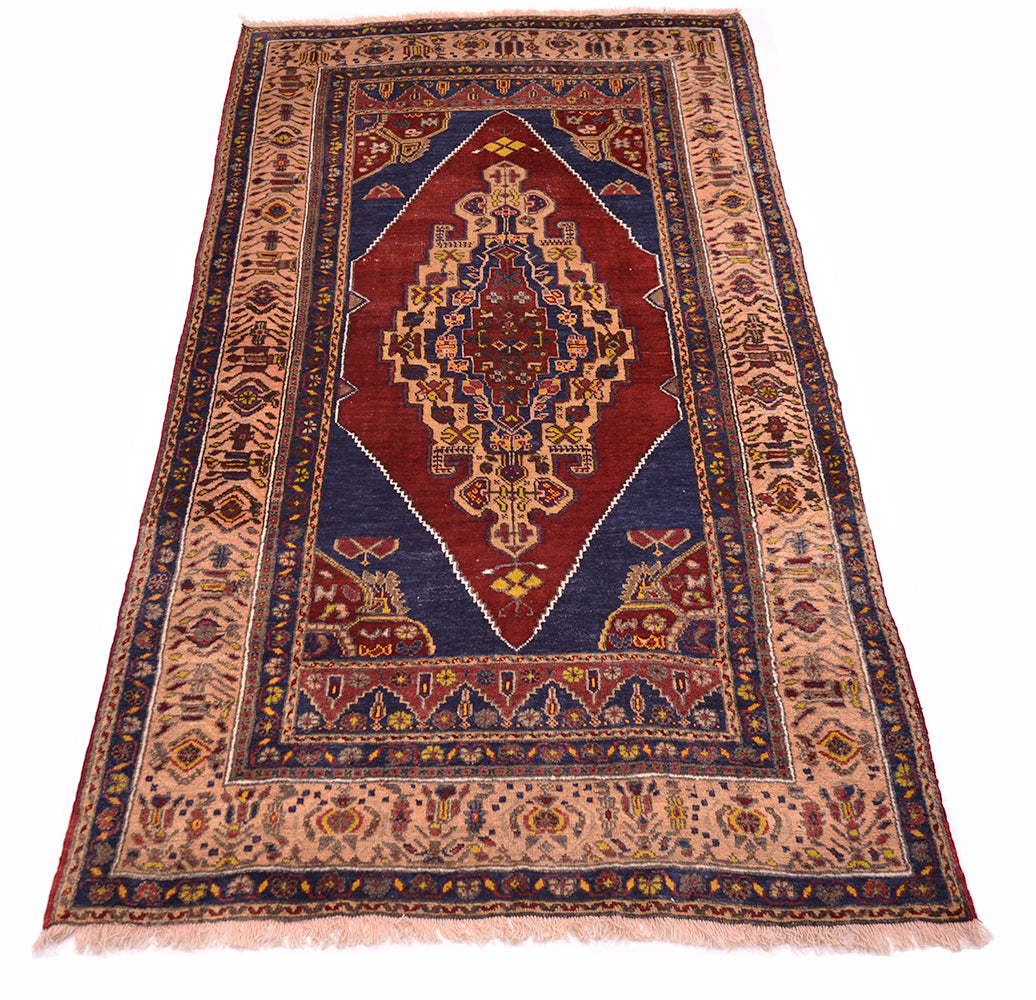 A traditional Yahyali-style Turkish area rug with a central red diamond medallion, navy blue borders, and beige accents, shown flat against a white background.