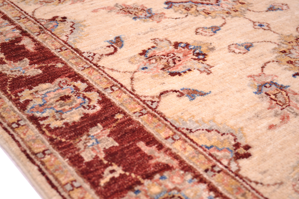 Detail of handknotted pure wool pile Ziegler Rug with blue and pink terracotta outlining.