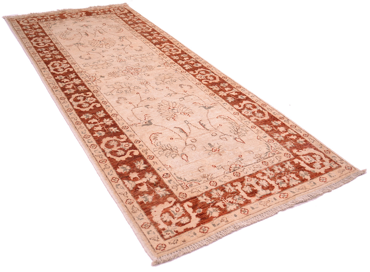 Angled views of Ziegler runner strip with golden cream main field floral leaves and tendrils with decorative floral border wirh rust amber background