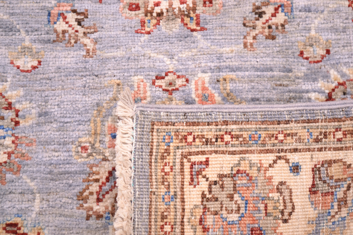 Reverse of handknotted rug in soft colours creams and blue-greys