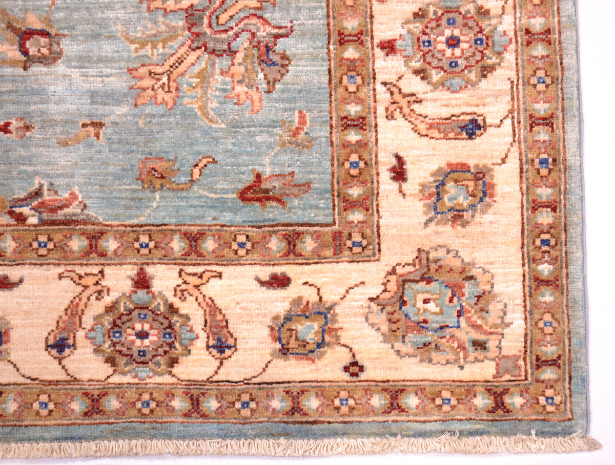 Border and corner detail of handwoven carpet with cotton warp fringes and natural vegetable dyes