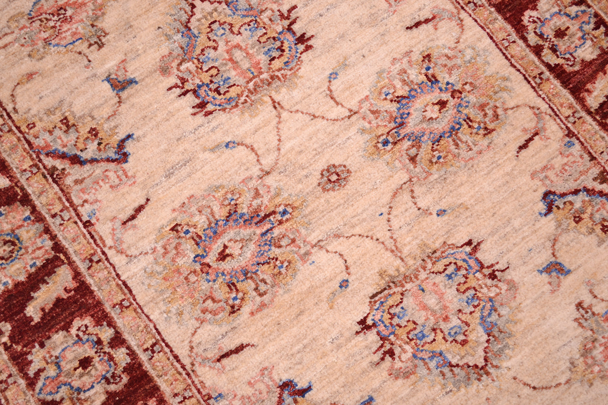 Detailed view of main field of Ziegler runner with sky blue detailing and soft salmon pinks