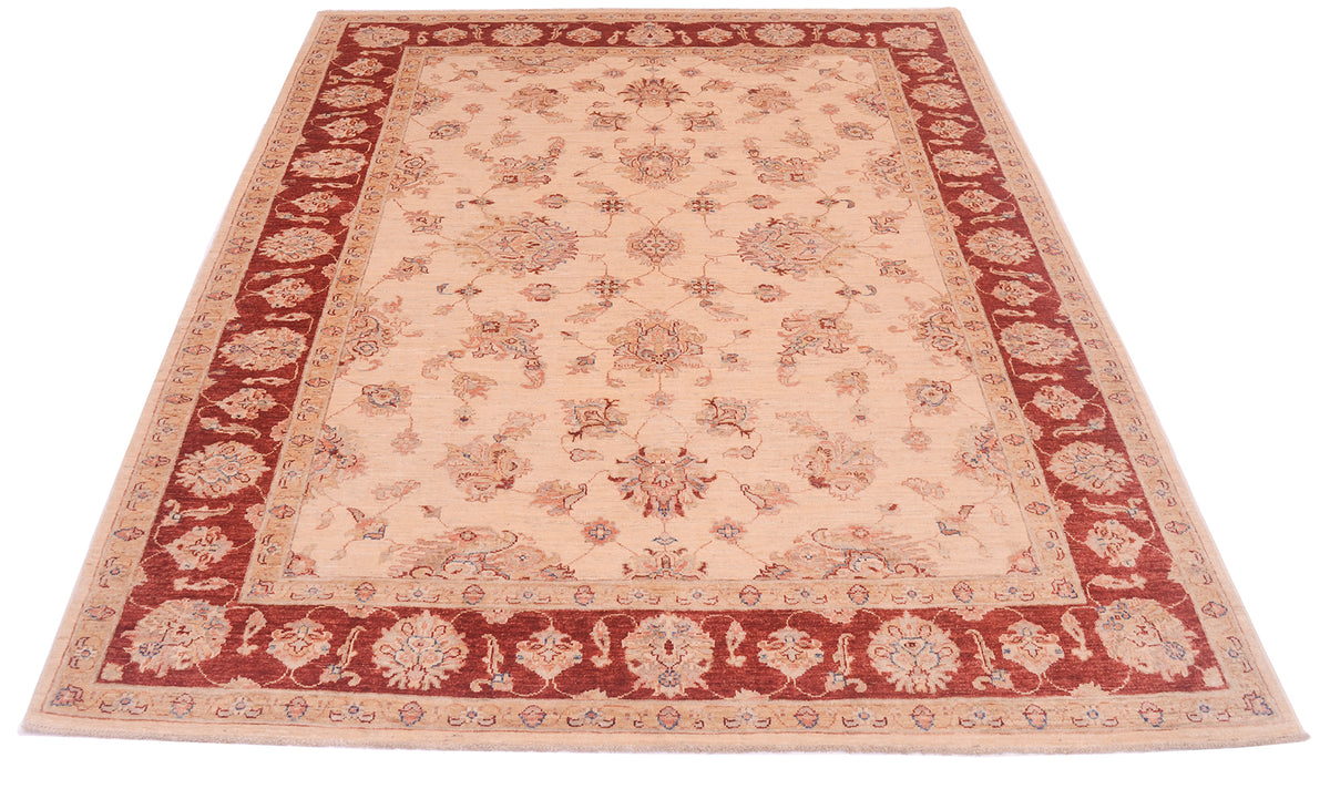 Pure wool pile pf classic ziegler design carpet with multiple floral motifs and cream field and rich red and cream decorative border.