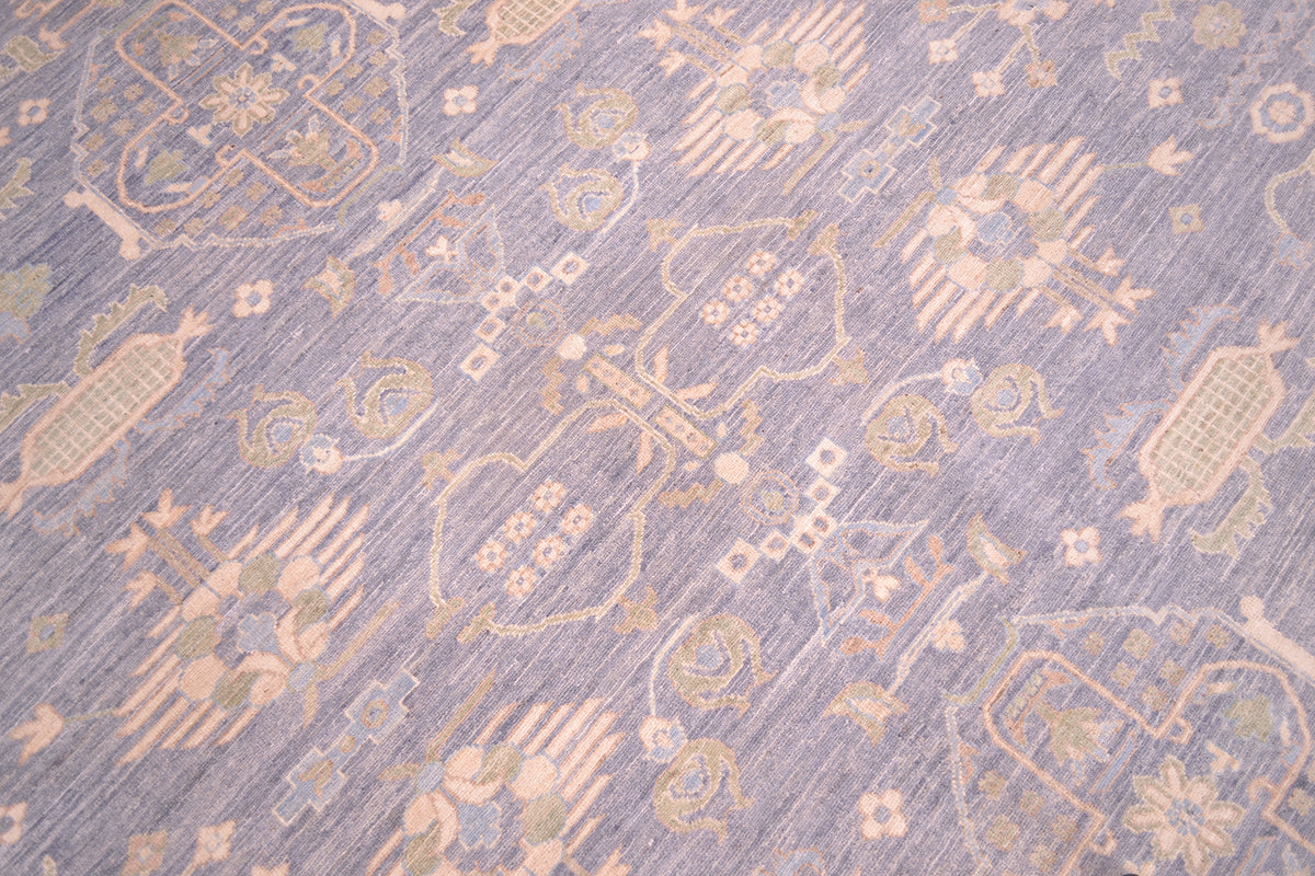 Close-up of pastel blue rug weave with small gold and cream motif pattern