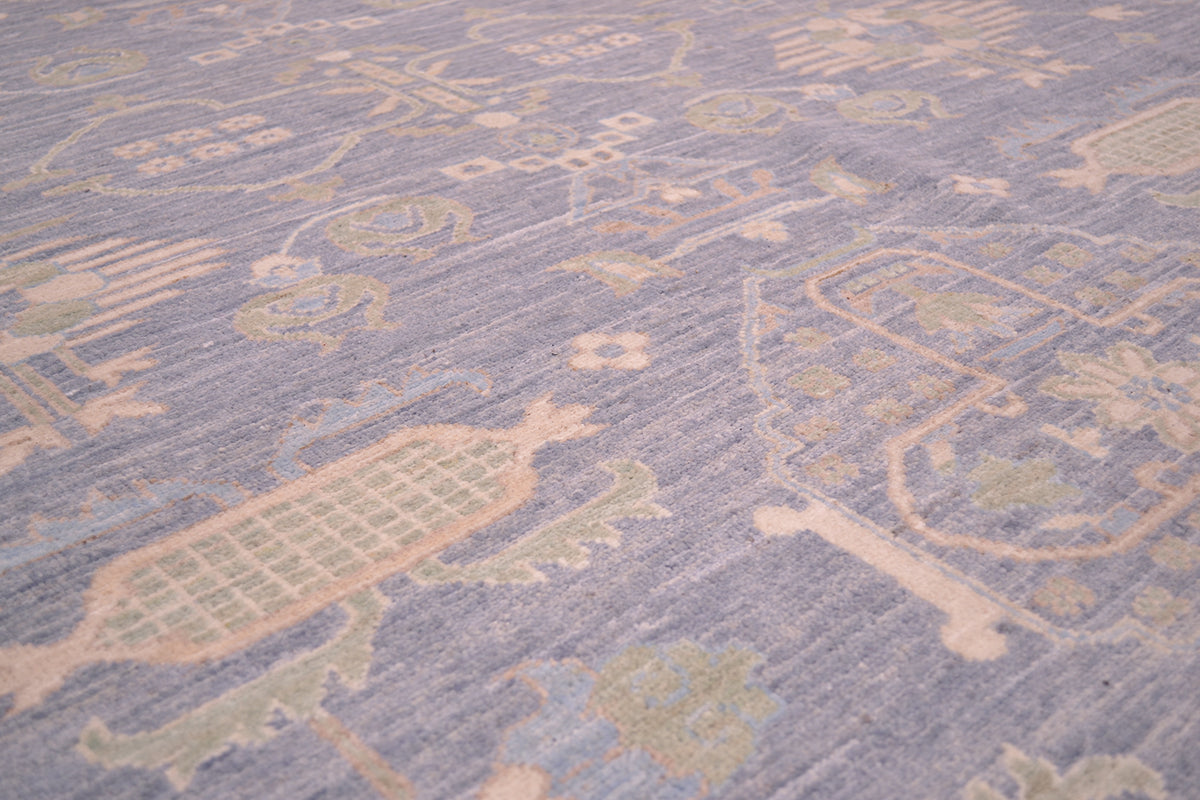 Close-up of pastel blue rug surface with geometric lines and soft motif shapes