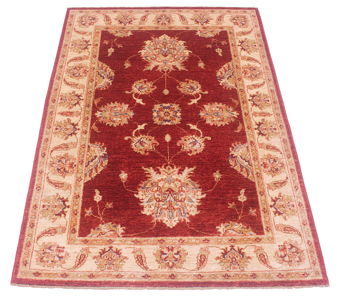 Detail of spacious format of red field of handknotted Afghan Ziegler Rug.