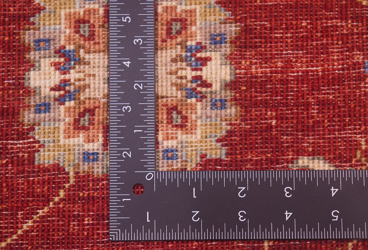 Reverse of handknotted rug in red, cream and gold. Fine weaving with natural vegetable dyes.