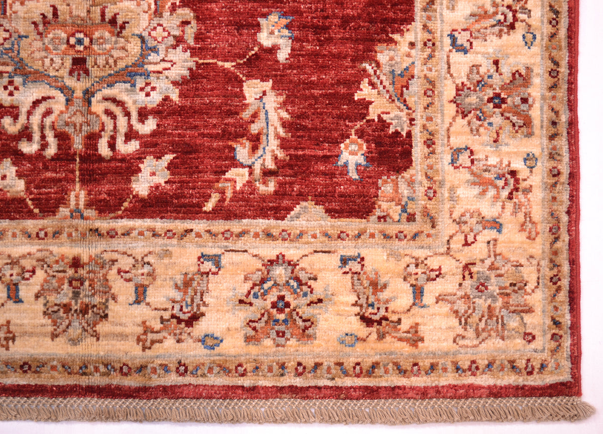 Corner of handknotted carpet with cotton warps in lattice design.