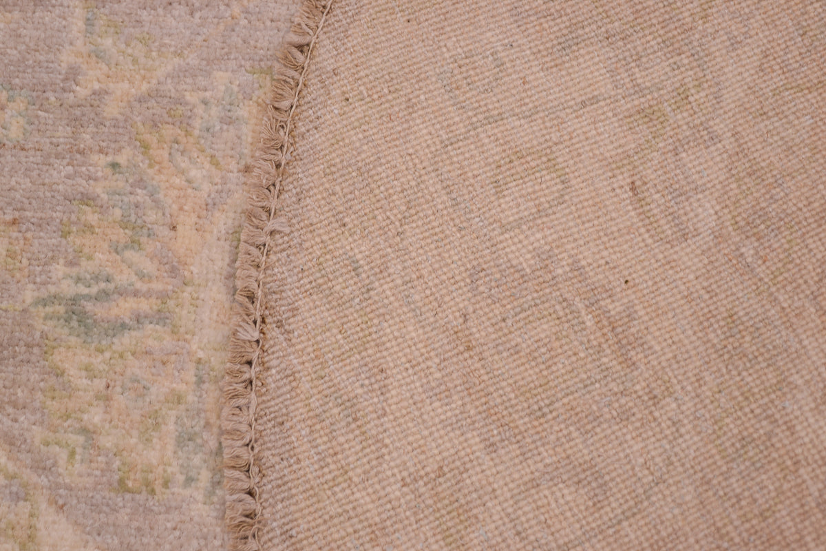 Reverse of soft coloured afghan ziegler rug showing back of knots and cotton foundation warps.