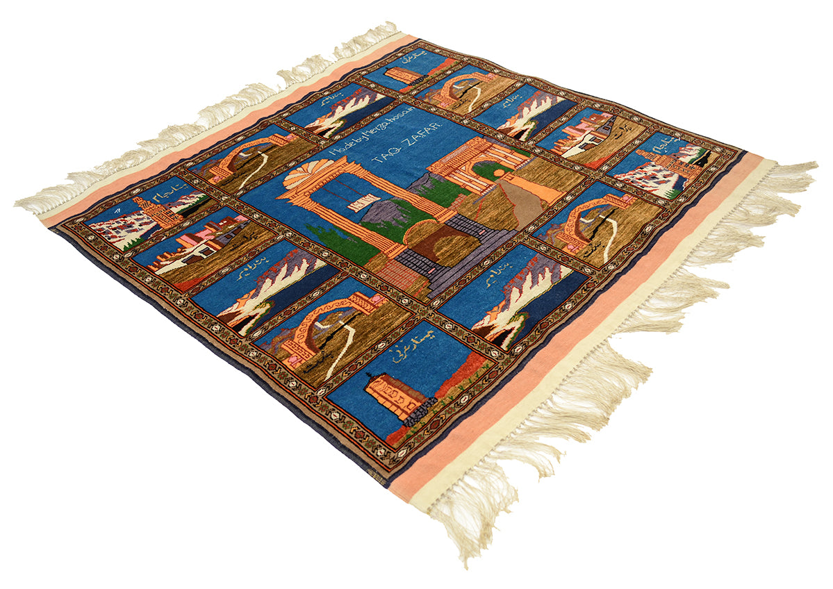 A fine Afghan Kabul pictorial wool and silk rug with cream fringe on all sides, featuring a detailed multicolour design with blue, orange, brown, and green sections depicting architectural and cultural motifs.