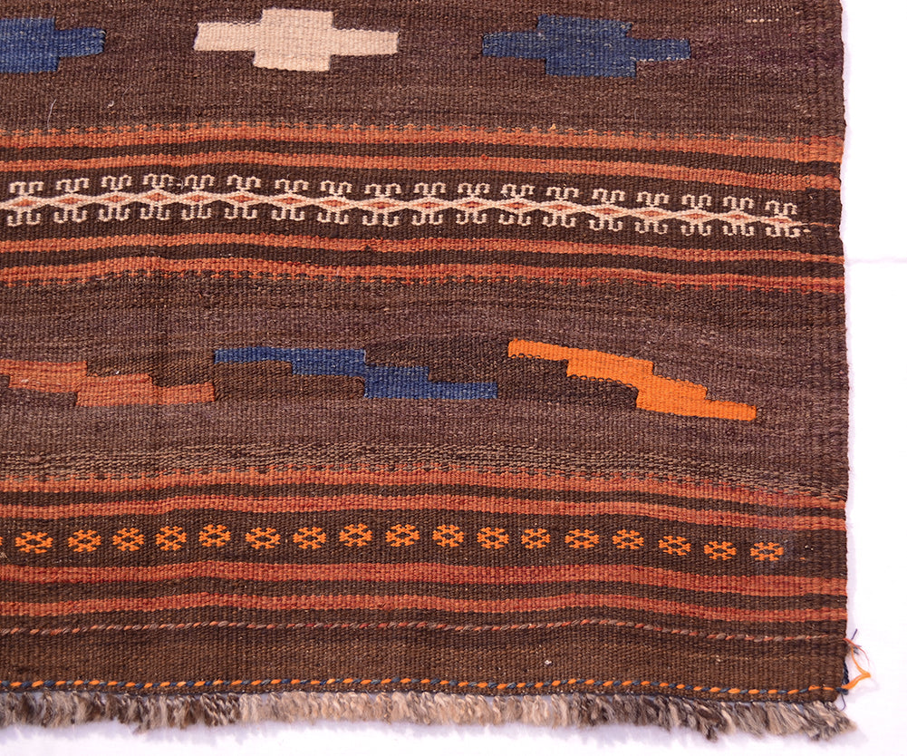 Qala-i-Nau kilim rug close-up with brown field, orange stripes, blue motifs, fringed edge