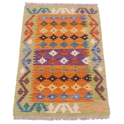 A handwoven kilim rug with a vibrant geometric pattern in orange, purple, blue, brown, and beige, featuring fringed edges on a white background.