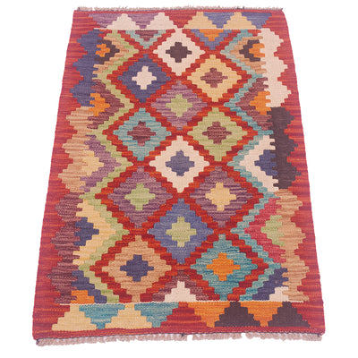 Handwoven kilim rug with red border and multicolor geometric medallion pattern