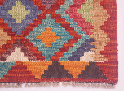 Close-up kilim rug with blue, red, cream and yellow flower-like star motifs