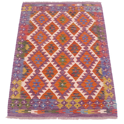 Kilim rug in purple and orange with repeating diamond and cross patterns, flat woven.