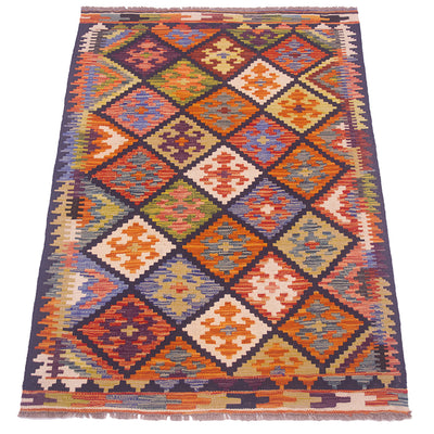 A kilim area rug with a vibrant geometric diamond pattern in orange, blue, beige, and purple