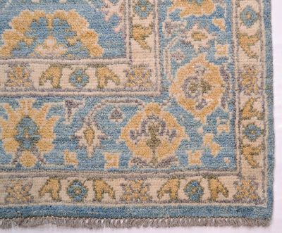 Corner detailing and wool warp fringe on handknotted afghan oushak carpet