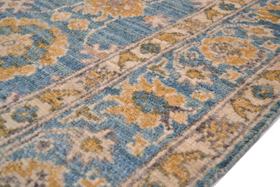 Detail of handknottign border of Abshari Ushak Carpet with cream, gold and turquoise