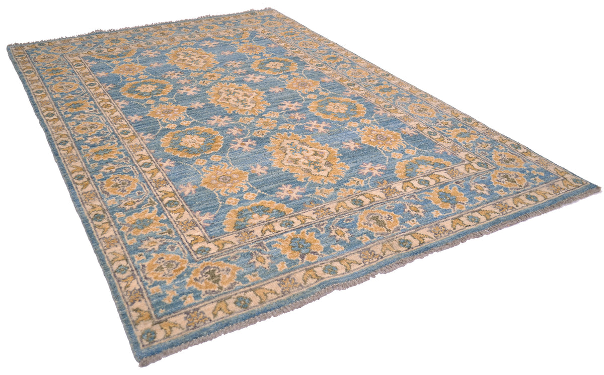 Angled view of handknotted pure wool carpet in turquoise and golden tones