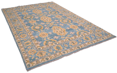 Angled view of handknotted pure wool carpet in turquoise and golden tones