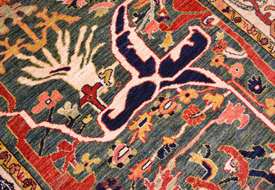 Close up detail of main field of Antique style Bidjar garous design carpets handknotted in Afghanistan with rich colouration with teal green main feild background and light cream highlights.