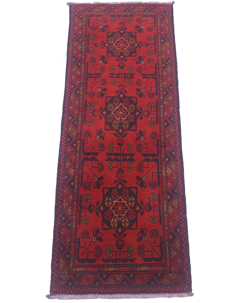 Red patterned rug runner with central medallion and decorative border