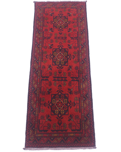 Red patterned rug runner with central medallion and decorative border