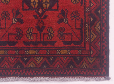 Red rug runner edge with border pattern and textured pile
