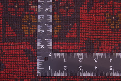 Red patterned rug runner with ruler measuring dimensions
