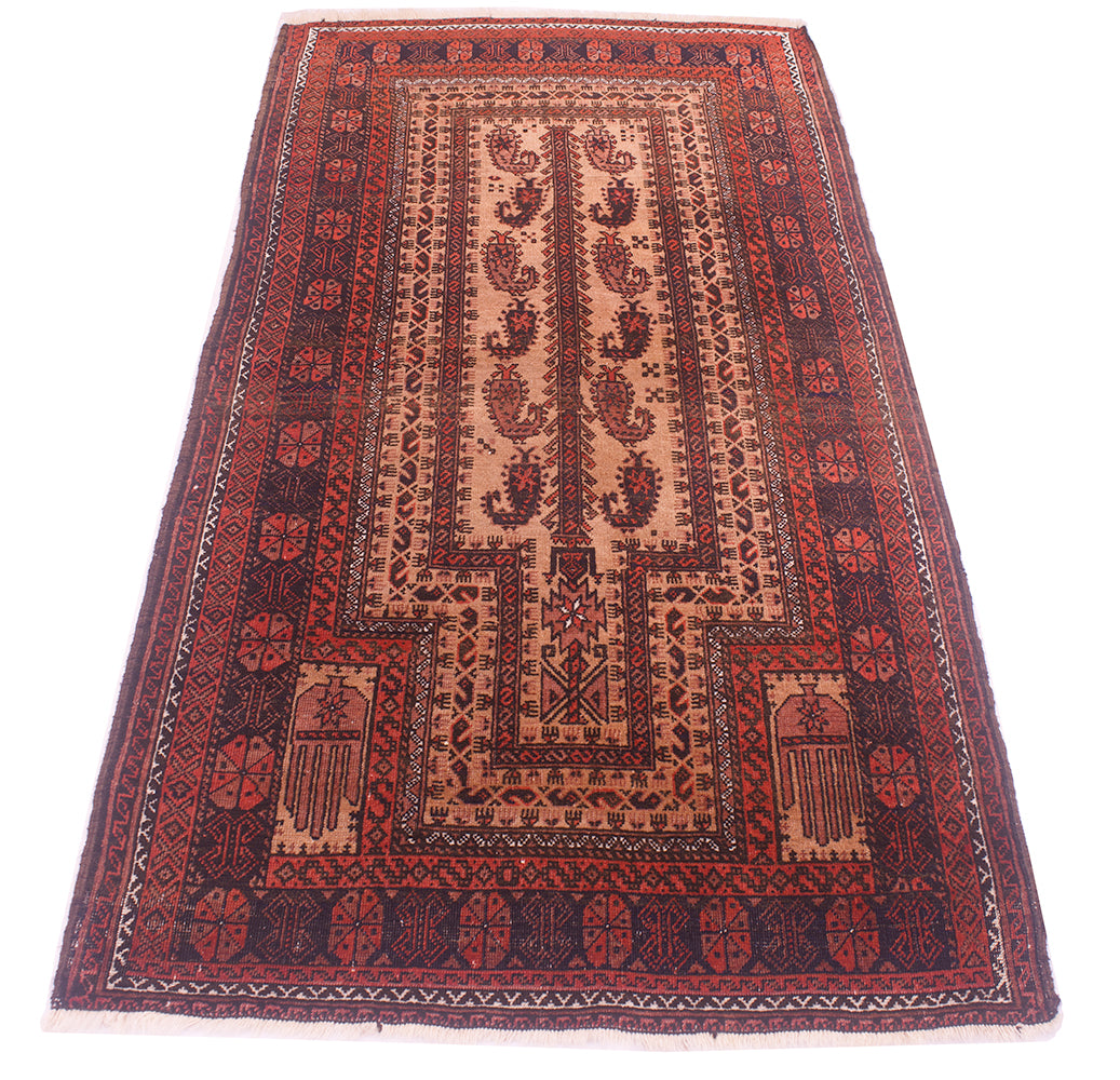 A rectangular handmade antique Belouch prayer rug with a traditional geometric and floral pattern, featuring a central mihrab design in red, brown, and beige tones, photographed flat against a white background.