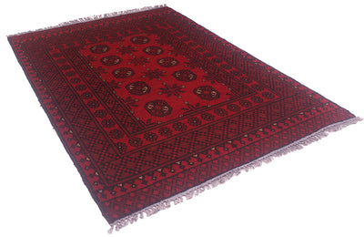 A red and black patterned Afghan rug with fringed edges, shown from an elevated angle on a white background.