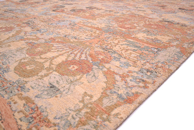 Detail of handknotted carpet with light blues, greens, and golds with terracotta pink/peach tones with antiquated  vase design flowerheads in all over design.  Light beige ground colour.