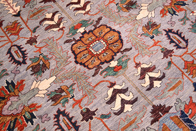 Close up detail of main field of Afghan with antique Persian design vocabulary with modern saturated colours. Angular palmette and leaves with lobed rosettes. Soft teal greens accents also in main field design.