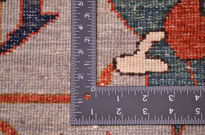 Reverse of handknotted carpet showing detail of knotting and natural vegetable dyed pure wool with teals, grey ands rust-orange. 