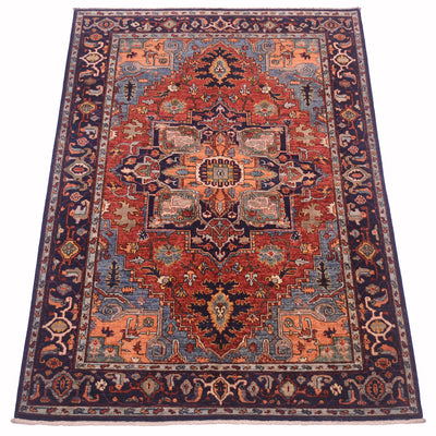 Navy border rug with red center medallion and light blue geometric motifs
