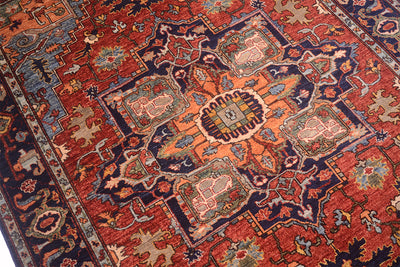 Close-up of rug weave with red, orange, blue and beige geometric motifs
