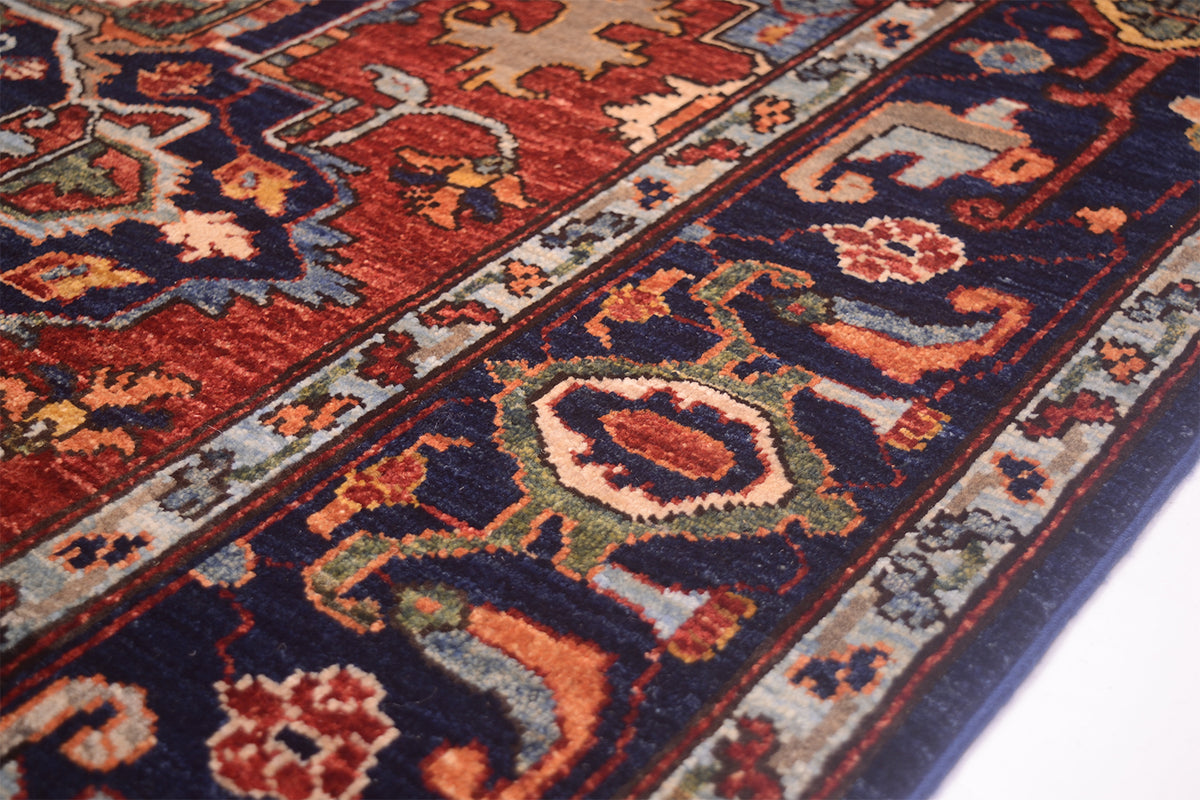 Close-up of rug corner with multicolor geometric pattern and navy border