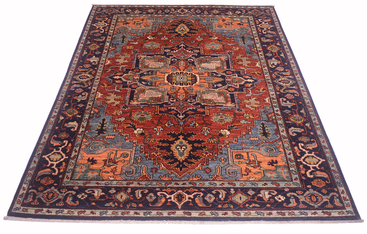 Red and navy patterned Heriz rug with central medallion and ornate corner details