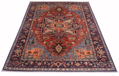 Red and navy patterned Heriz rug with central medallion and ornate corner details