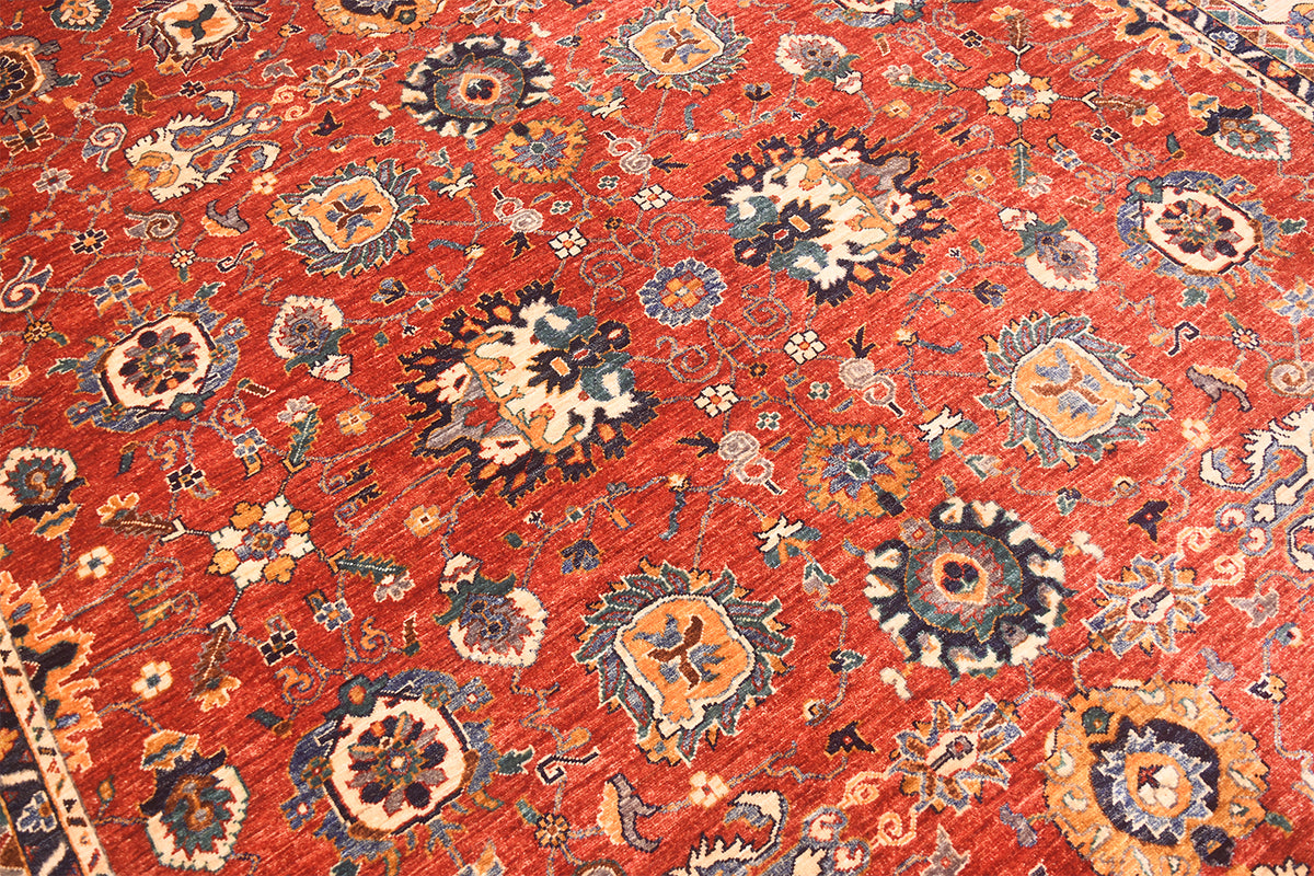 Handknotted Sultanabad design carpet close-up, red ground with multicolor floral motifs