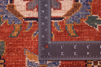 Handknotted Sultanabad design carpet weave close-up with ruler across red pattern