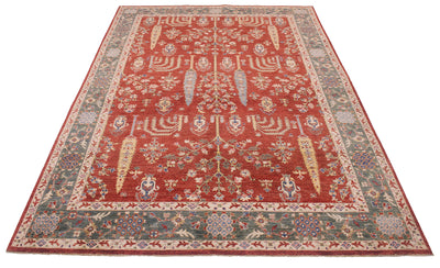 A rectangular traditional Afghan fine Aryana pictorial area rug with a red central field, detailed floral motifs, and a patterned border in muted green, beige, and red tones, shown flat against a white background.
